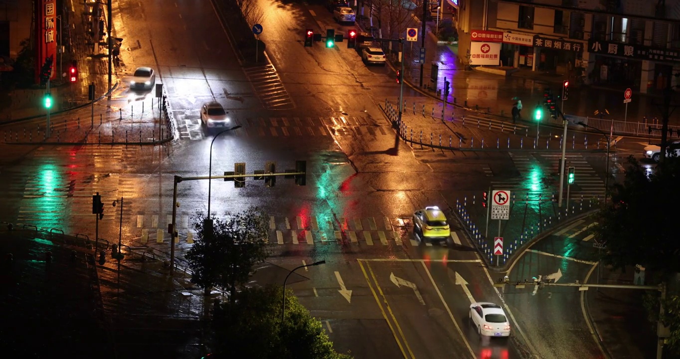 城市夜景风光：下雨夜景灯光下的重庆南岸区丁香路与桂雨路交叉十字路口视频素材