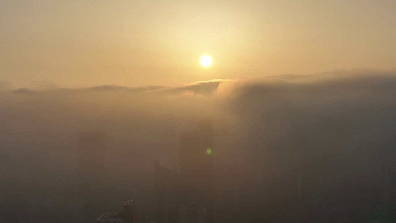 航拍上海城市旅游地标建筑景观——上海平流雾中的摩天大楼建筑群视频素材