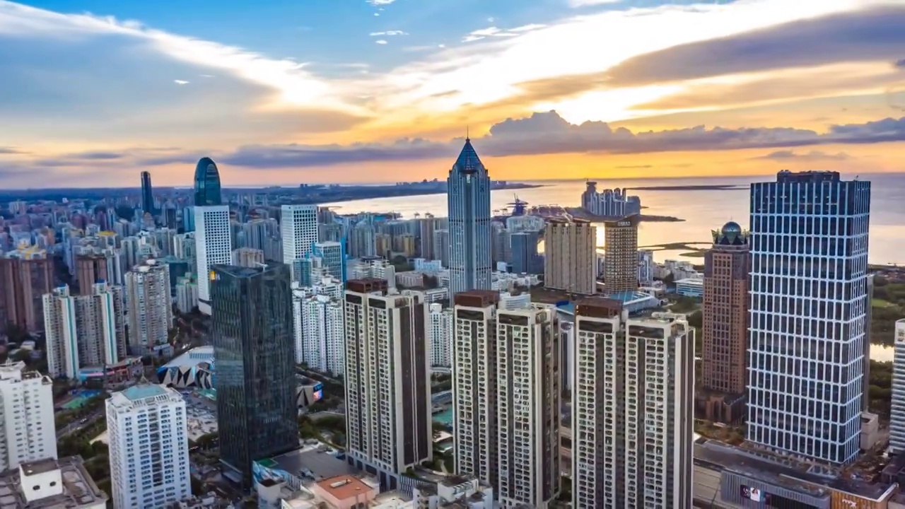 海南省海口市自贸港滨海核心区摩天大楼落日航拍延时摄影视频素材