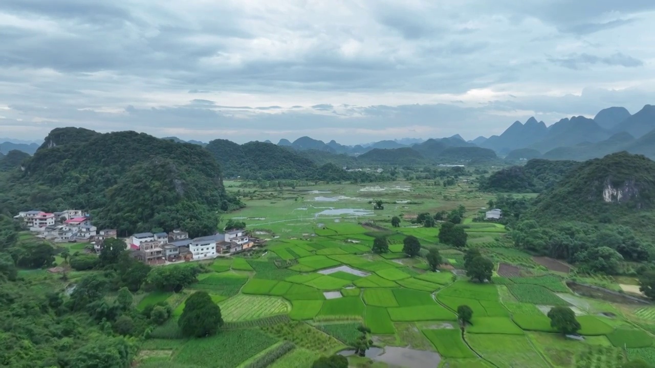 蓝天白云下喀斯特地貌峰林间的田园风光视频素材