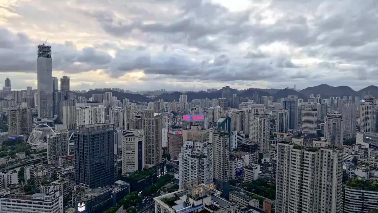 中国贵州省贵阳市观山湖区夕阳映照下核心商务区CBD蓝天白云下的城市风光固定机位延时摄影视频素材