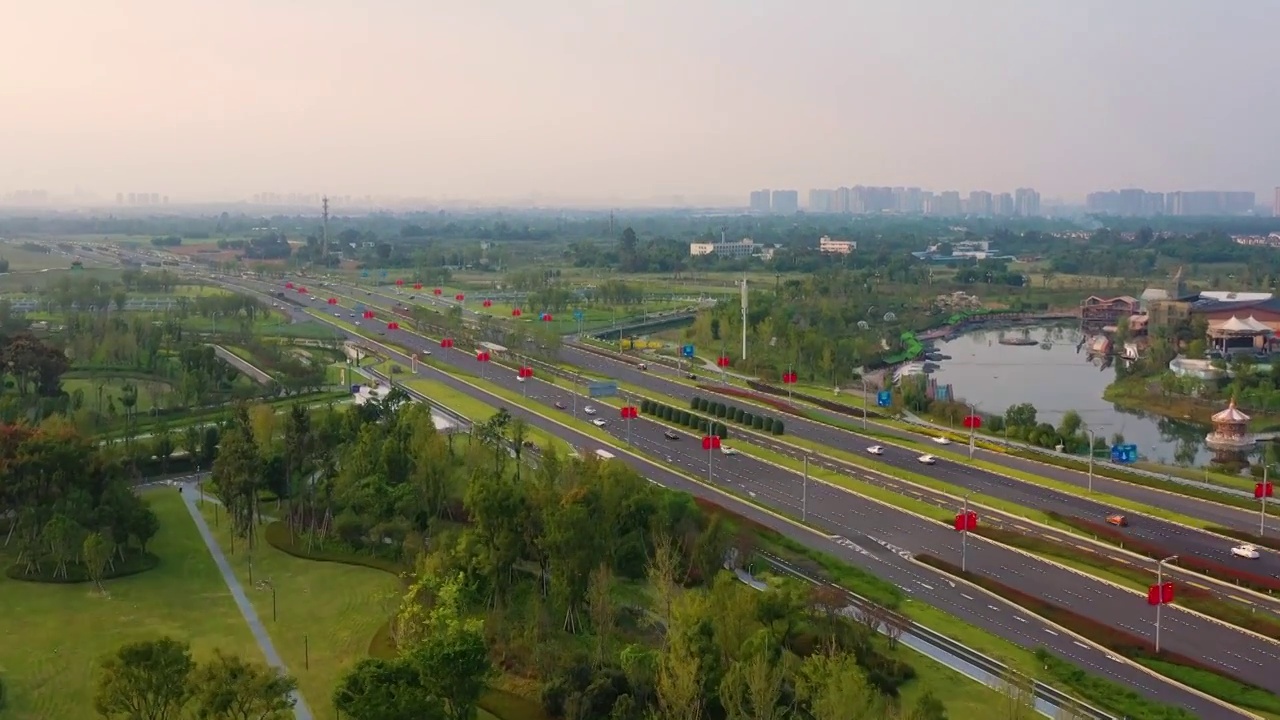 航拍高速公路交通车流和城市绿化景象视频素材