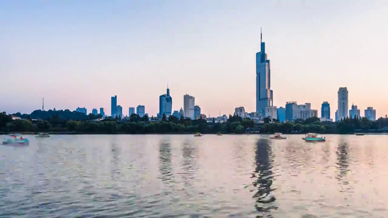 中国江苏南京紫峰大厦和玄武湖上的游船延时摄影航拍夜景视频素材