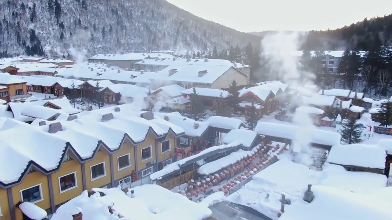 航拍雪乡梦幻雪景袅袅炊烟视频素材