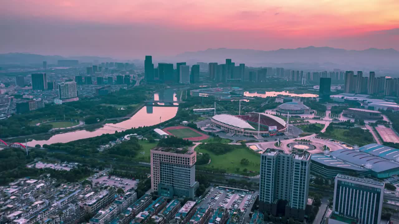 浙江义乌市体育馆城市地标朝霞风光航拍延时摄影视频素材