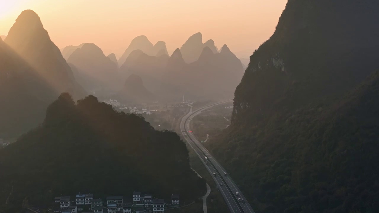 黎明日出时分在喀斯特地貌峡谷中穿行的高速公路视频素材