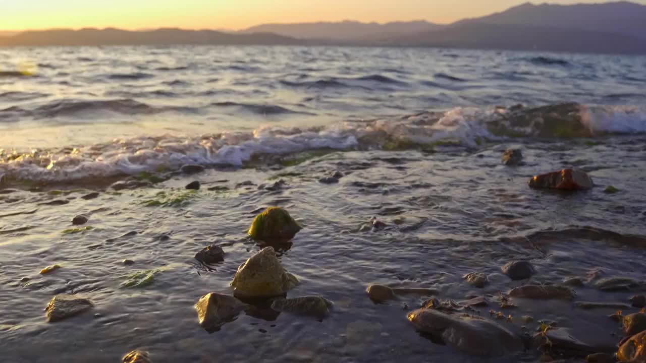 云南玉溪抚仙湖的日落水面浪花唯美空镜视频素材