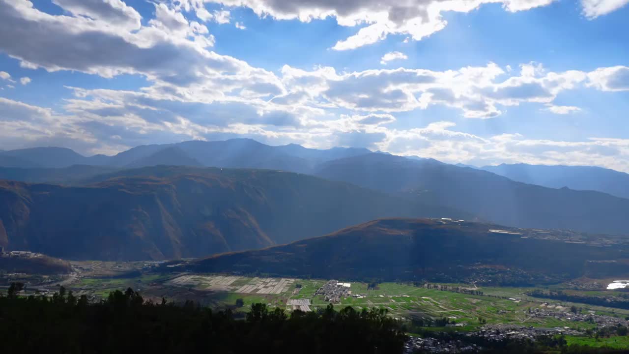 中国云南山川田地光芒云朵延时视频素材