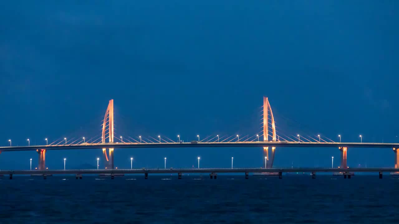 延时摄影夜晚时分的港珠澳大桥风帆塔海上月亮升起的景观视频素材