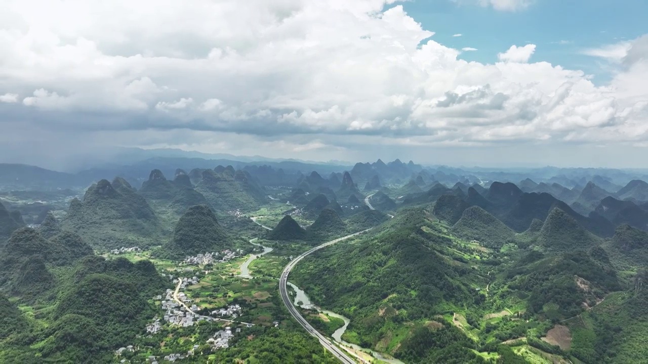 蓝天白云阳光下桂林喀斯特山峰间的高速公路视频素材