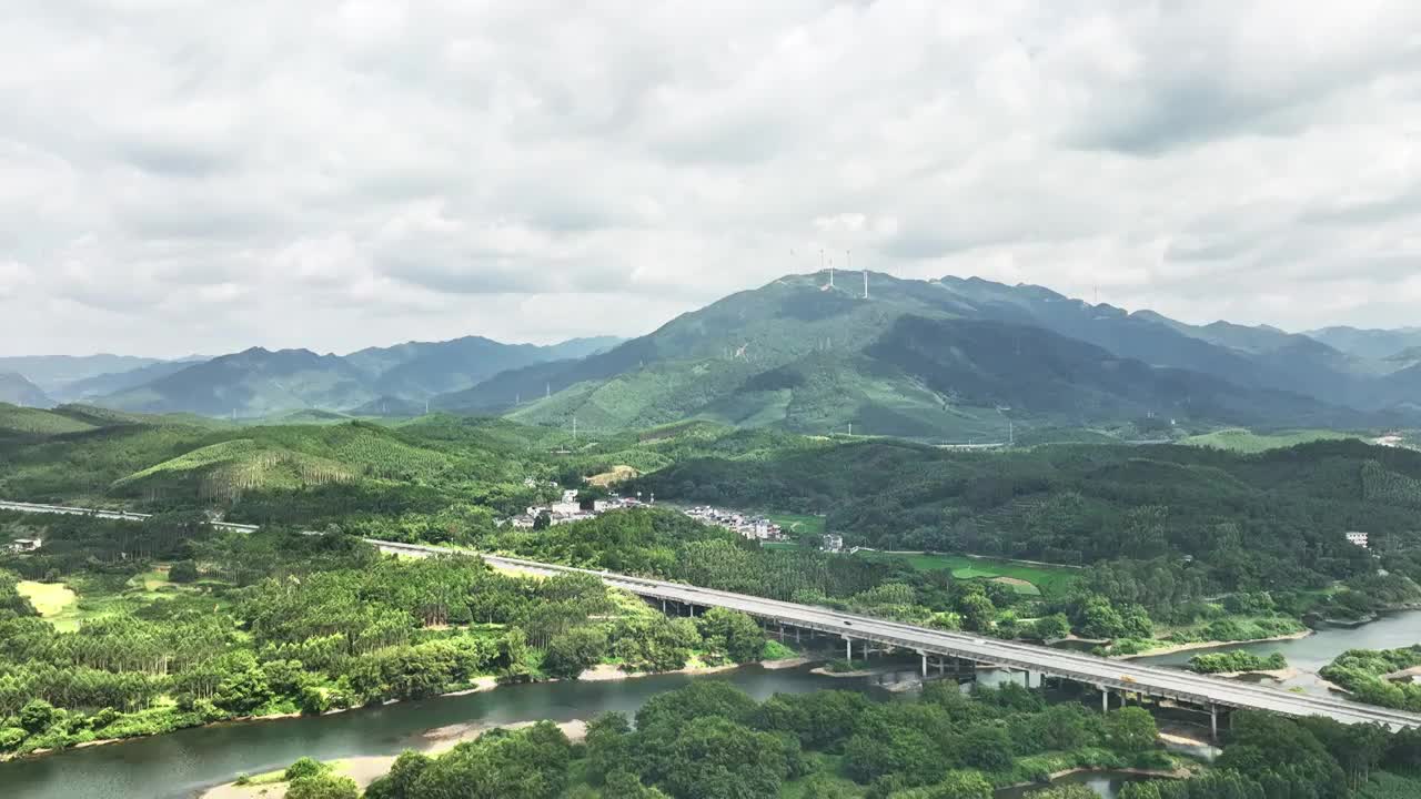 蓝天白云下山谷中的横跨河流的高速公路视频素材