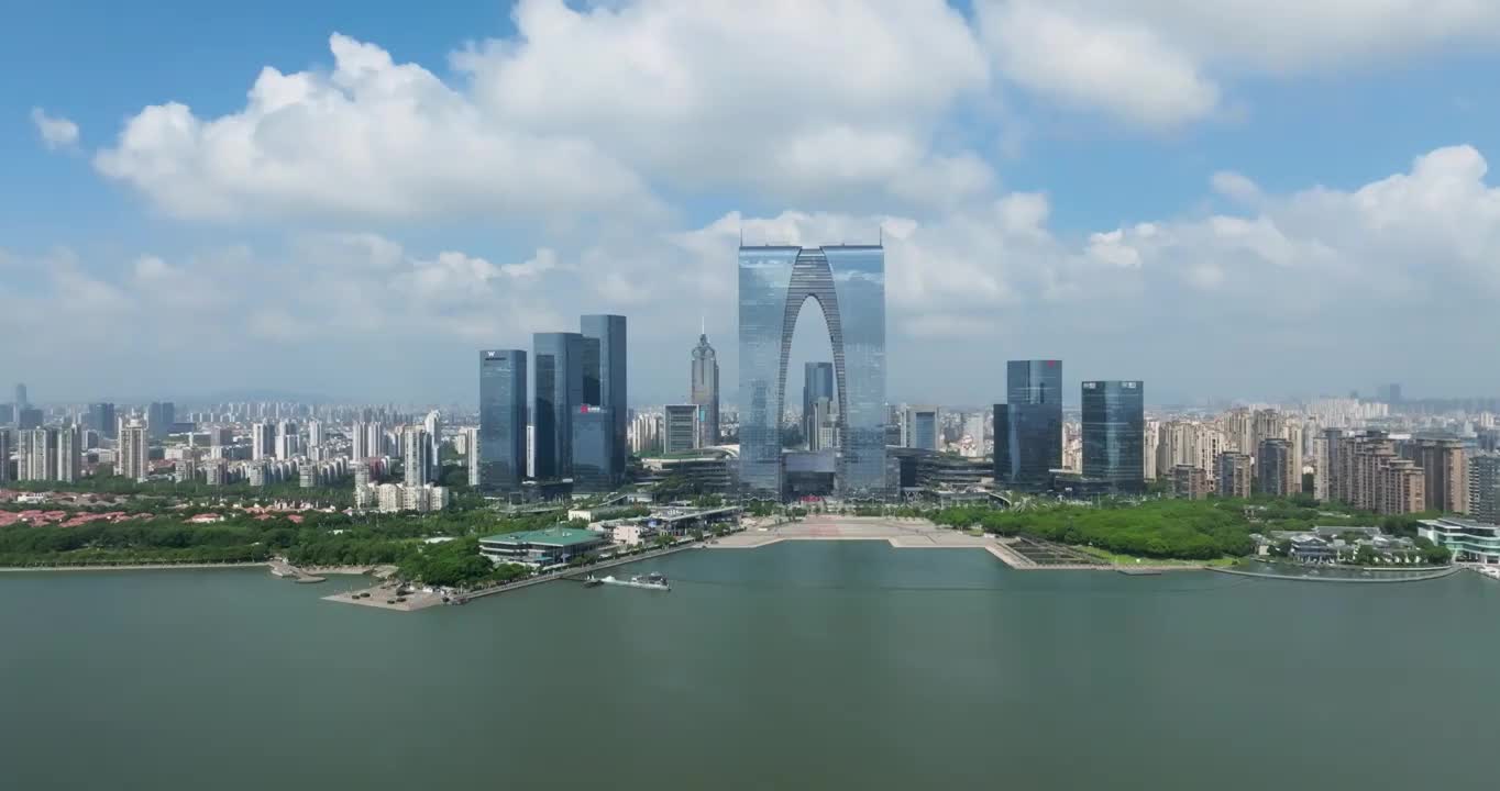 蓝天白云下的江苏省苏州市金鸡湖风景区城市建筑东方之门航拍风光视频素材