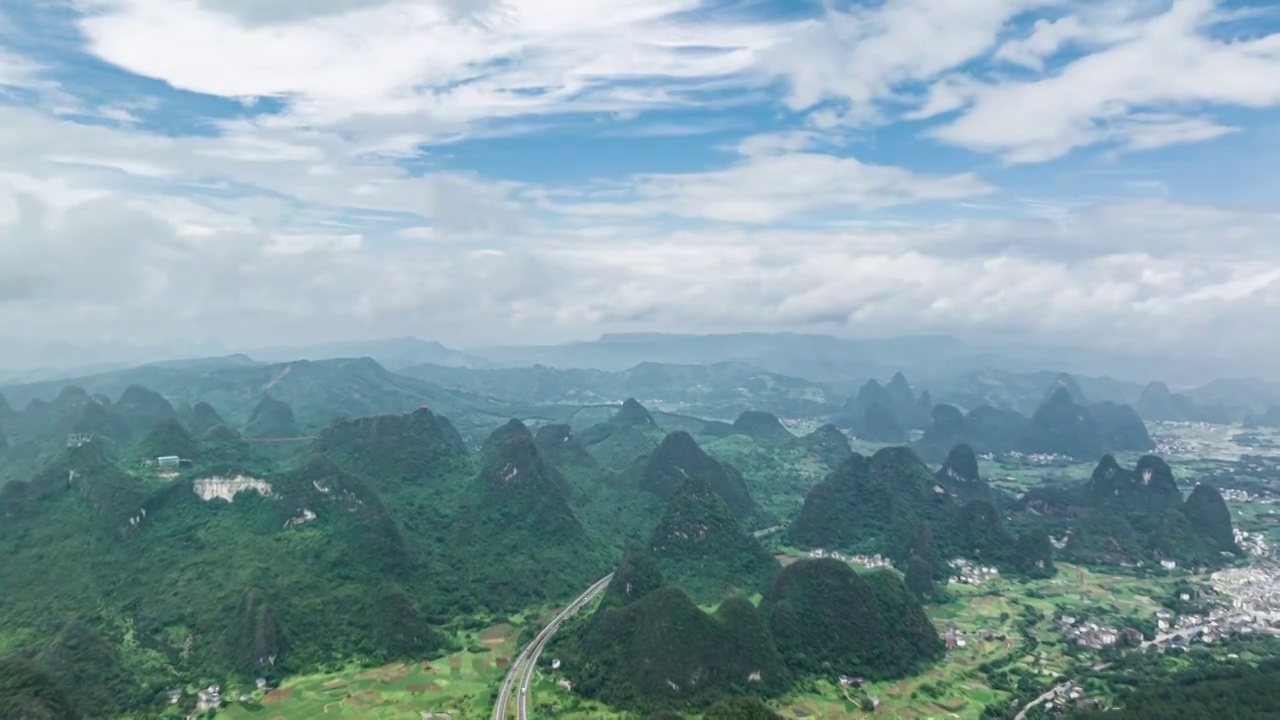 航拍桂林喀斯特地貌山谷中穿行的高速公路视频素材