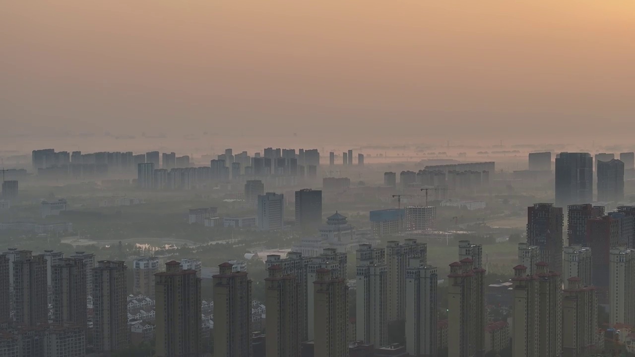 高视角航拍周口东区晨雾日出城市大景视频素材