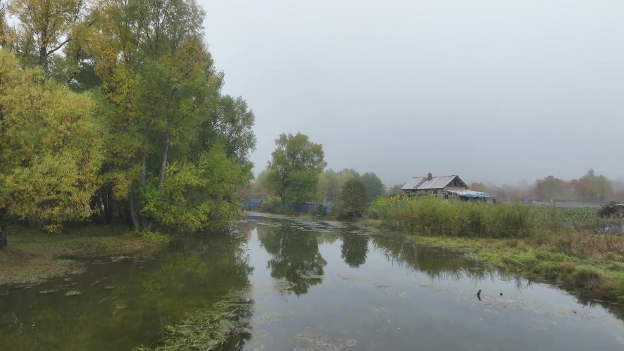 晨雾中河岸山里人家视频素材