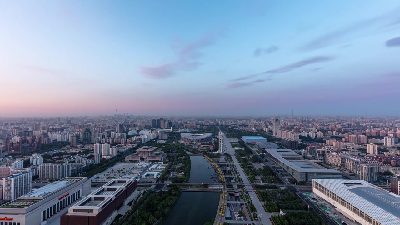 北京朝阳区奥林匹克塔航拍视角中轴线鸟巢景观大道日出延时摄影视频下载