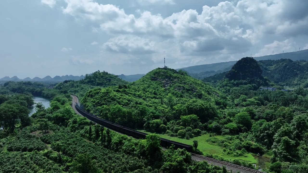 蓝天白云阳光下桂林山边小河旁铁路上行驶的货运列车视频素材