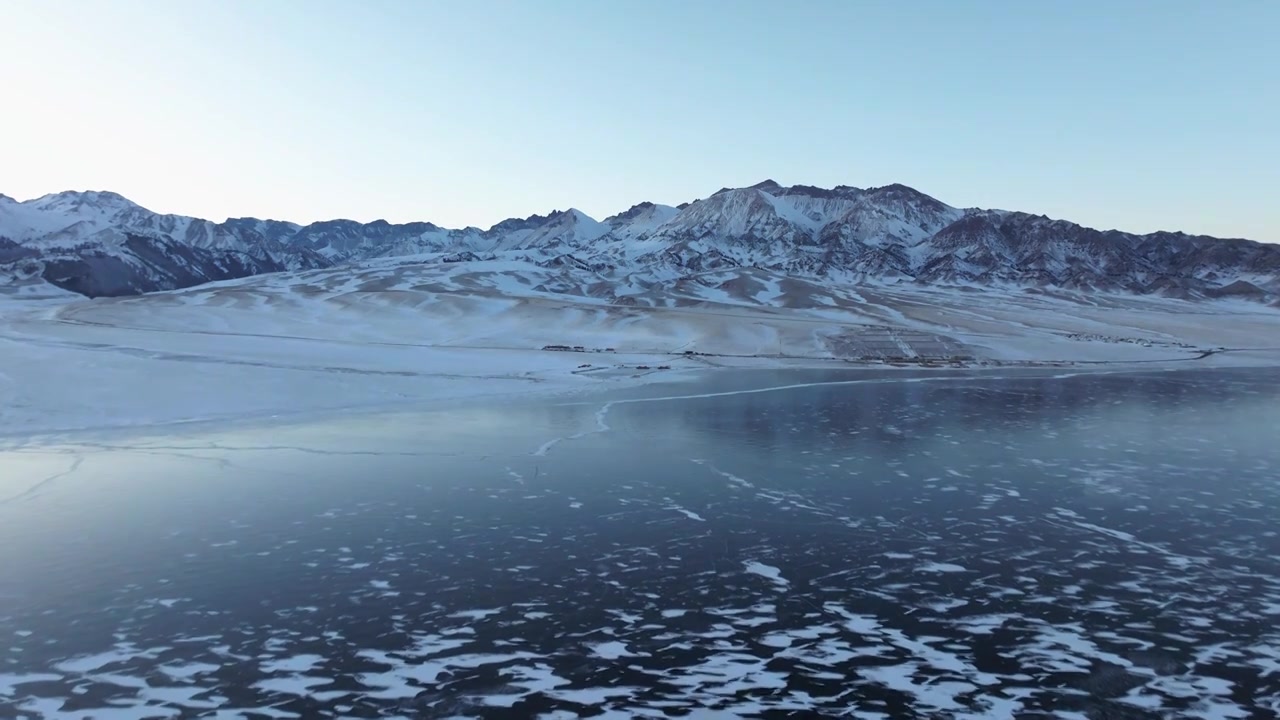 航拍冬季新疆赛里木湖雪山冰湖蓝冰日照金山夕阳雪山纹理视频素材