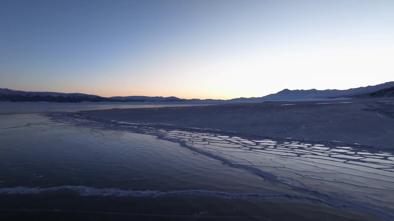 航拍冬季新疆赛里木湖雪山冰湖蓝冰日照金山夕阳雪山纹理视频下载