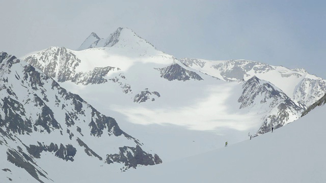 在奥地利阿尔卑斯山脉/斯图拜冰川上徒步旅行的三名登山者视频素材