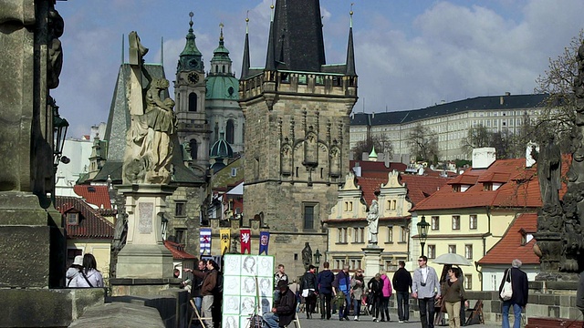 步行在查尔斯桥上的人们和艺术家坐在她的绘画/布拉格，Hlavni mesto Praha，捷克共和国视频素材