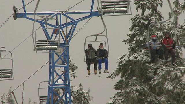 在加拿大不列颠哥伦比亚省的雪/露台滑雪缆车上乘客的MS视频素材