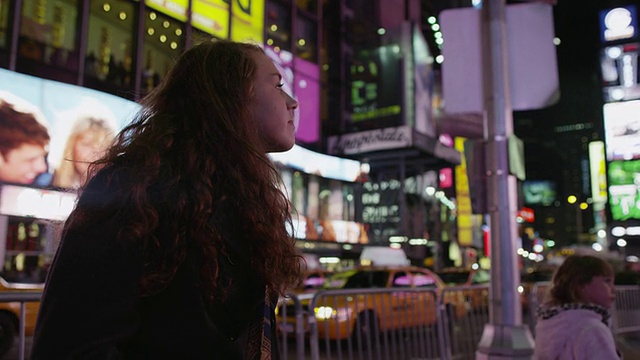 SLO MO MS少女坐在时代广场晚上/曼哈顿，纽约市，美国纽约州视频素材