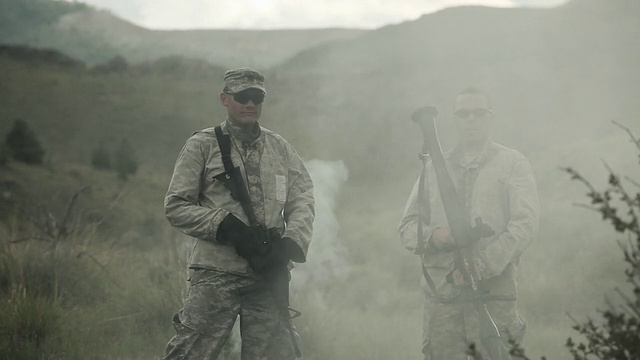 两名士兵站在一团正在消散的烟雾中。视频素材