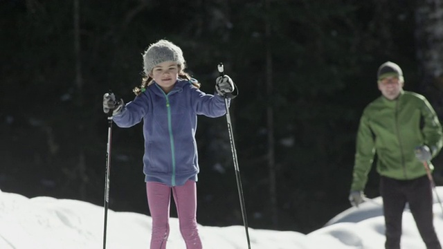 MS SLO MO TS年轻的女孩和她的父亲在冬天做越野滑雪/ Squamish, BC，加拿大视频素材