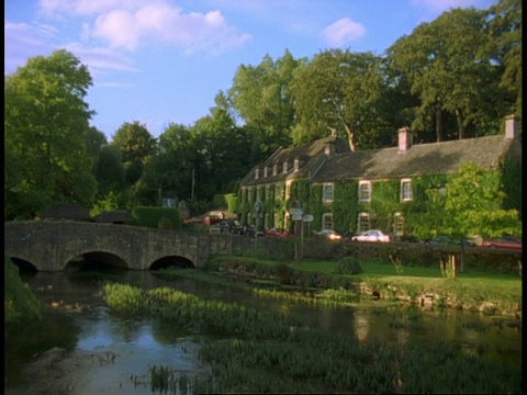 乡村建筑，天鹅酒店，科伦河和桥，Bibury -河上的鸭子，天际线上的树木视频素材