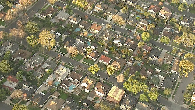 高角度空中跟踪左放大-一个住宅社区的特色漂亮的房子和私人后院游泳池。/美国加州洛杉矶视频素材