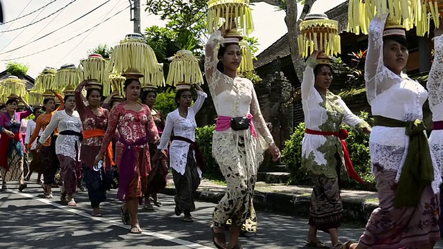 在印尼巴厘岛的乌布，妇女们把祭品顶在头上视频素材