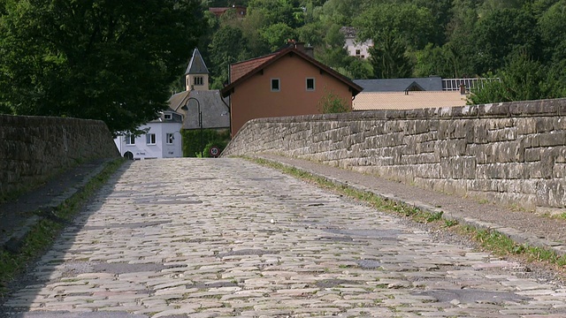 MS Shot of Cyclist at old Sauer Bridge / Dillingen, Echternach，卢森堡视频素材