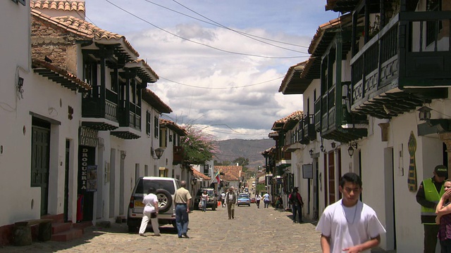 哥伦比亚，Villa De Leyva, BoyacÃ × department，俯瞰居住街道，人们和汽车，白色的房子和红色的瓦片屋顶视频素材