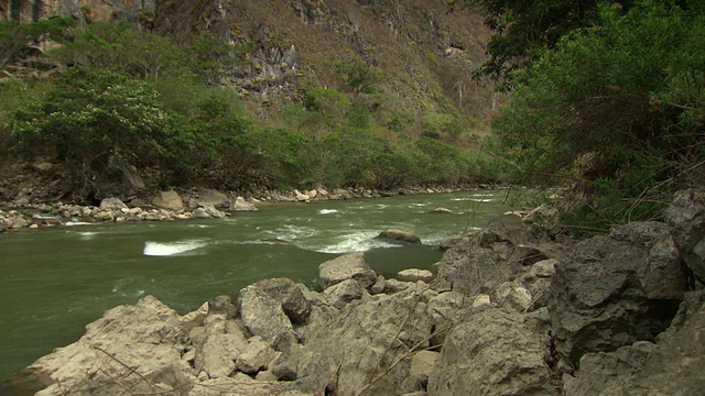 Pan up from green river rapids and river's edge to green mountain, Utcubamba river[里约热内卢Utcubamba]， Peru [PerÃº]视频素材