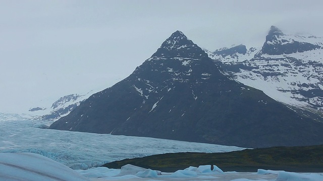 在冰岛的雨中，清晨的Fjallsarlon冰川湖上，许多冰川漂浮在平静的湖面上视频素材