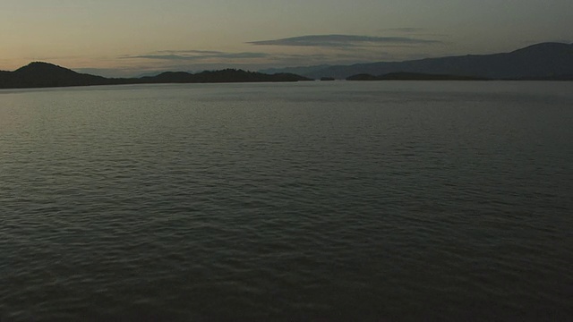 低跟踪平头湖在夜间与山脉的空中视图/蒙大拿，美国视频素材