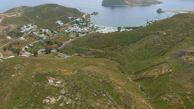 MS AERIAL拍摄的海岸附近的房屋和农田景观/帕特莫斯，Cyclades，希腊视频素材