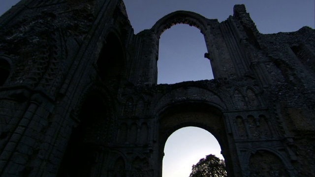 阿克城堡(Castle Acre Priory)废墟中的拱门勾勒出了英国诺福克郡的乡村风貌。高清。视频素材