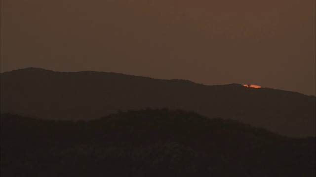 一缕阳光消失在山脉后面。视频素材