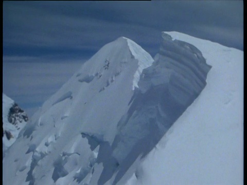 沿着山顶向前走，南岛后面美丽的雪山就显露出来了视频素材