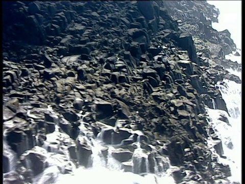 沿着崎岖不平的海岸，当海浪冲击岩石，北爱尔兰的波特拉什半岛视频素材