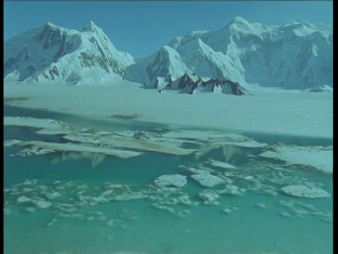 在育空的雪谷中，跟踪左边和缩小融化的水视频素材