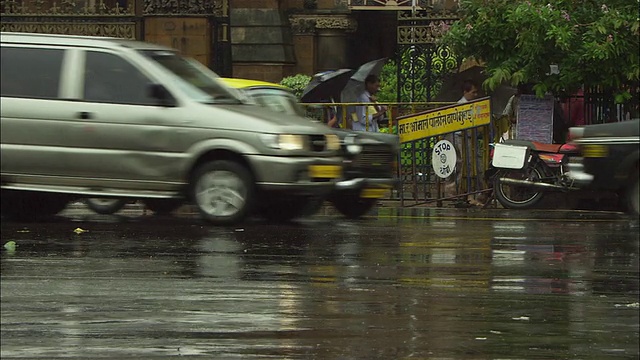 交通沿着一条繁忙的下雨的街道行驶。高清。视频素材