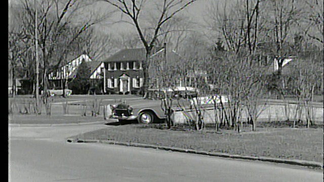 1955年在郊区街道上行驶的汽车/桥/雪佛兰视频素材