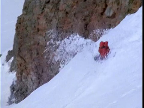 高角度滑雪板在红色夹克做旋转跳岩坡视频素材