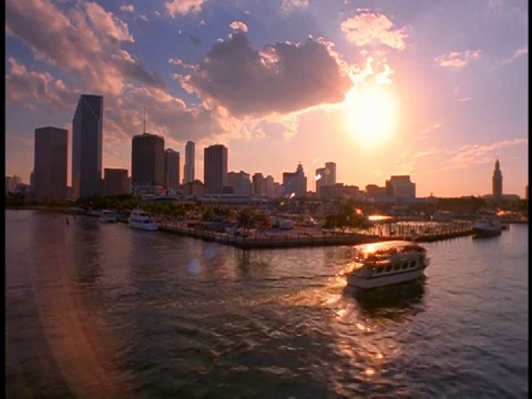 PAN渡轮沿着港口行驶/迈阿密天际线+日落背景/迈阿密，佛罗里达视频素材