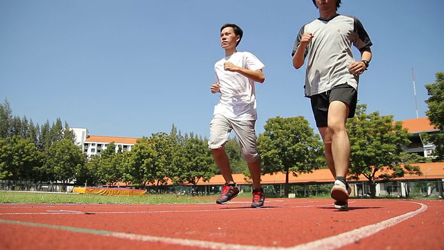 一对夫妇在运动跑道上跑步视频素材