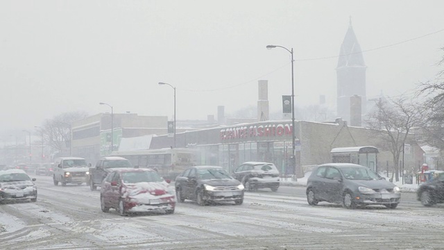 汽车在暴风雪中行驶在城市街道上视频素材