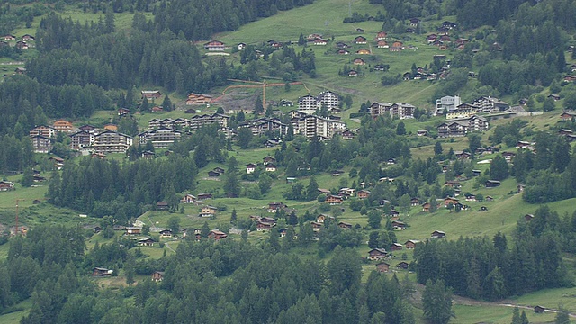 瑞士Nendaz / Valais，树木环绕的房屋的WS航拍照片视频素材